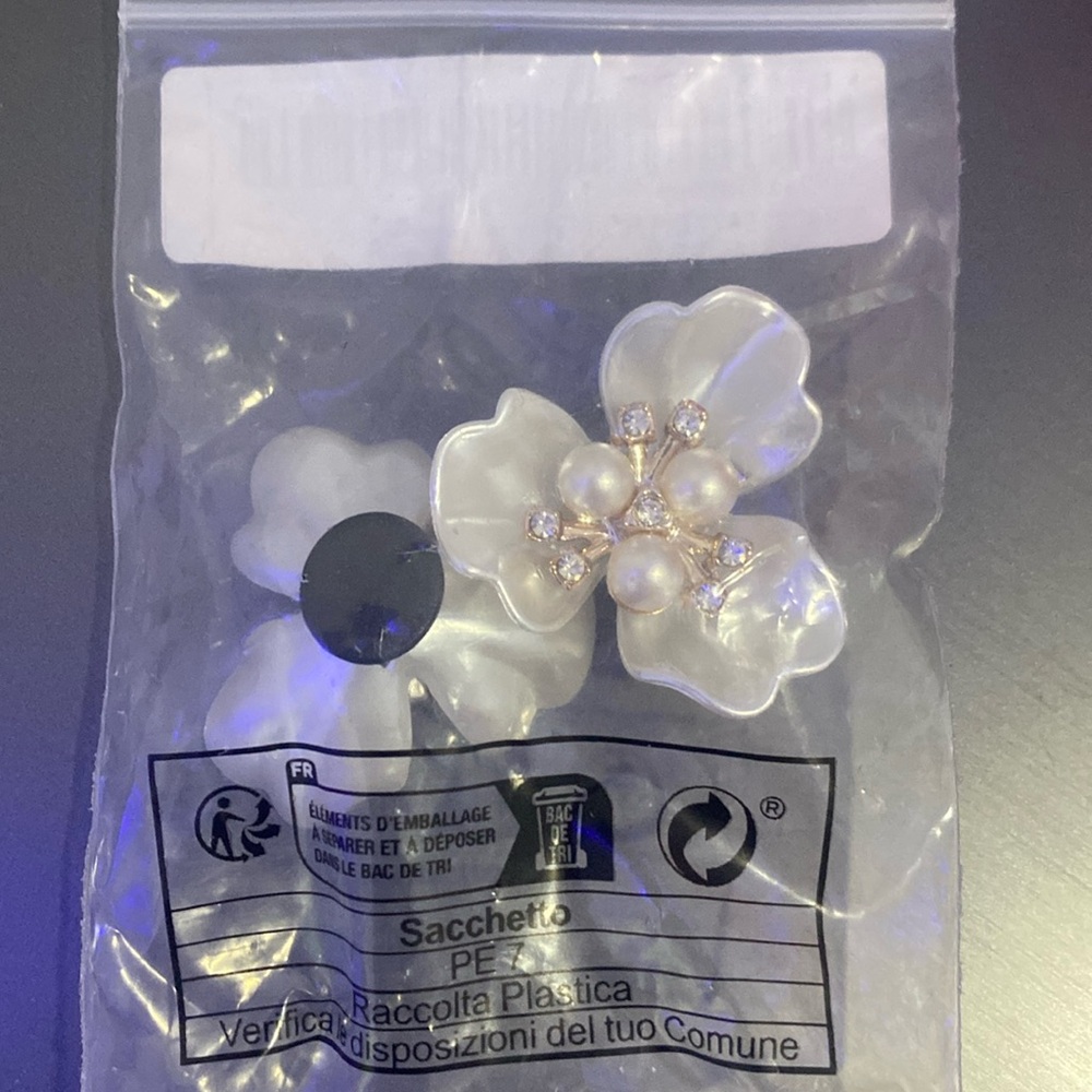 A white crocs charms flower